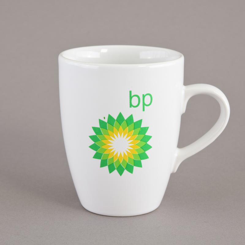White pottery mug with green and yellow BP logo