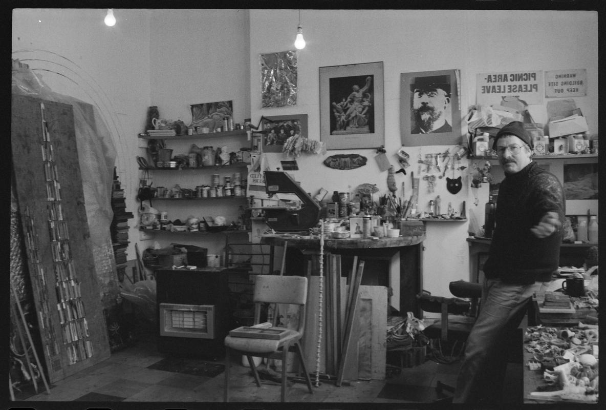 Interior of &#039;AADW&#039; Workshop, with a man leaning against a table. (Association of Artists and Designers in Wales Print Workshop).