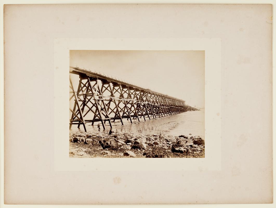 Construction of Barry No. 1 Dock showing view of a pier used for tipping stone. Mounted on card.