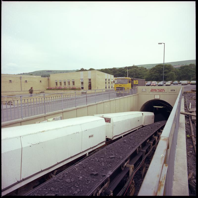 Colour film negative showing the entrance to the mine with man riding cars and conveyor, Betws Mine 10 June 1982.  &#039;10 Jun 1982&#039; is transcribed from original negative bag.  Appears to be identical to 2009.3/2179.