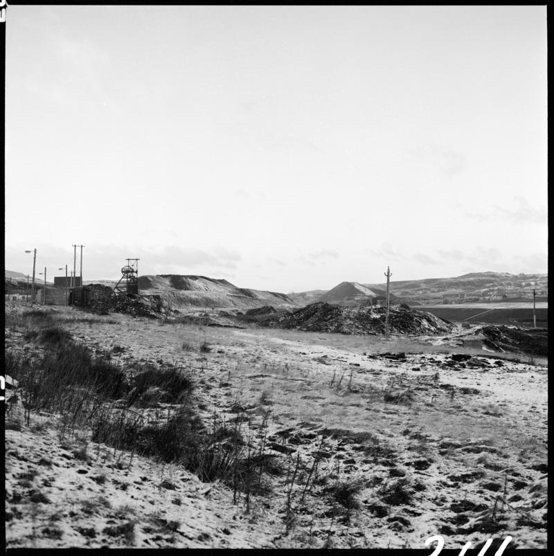 Black and white film negative showing the landscape surrounding Big Pit.  The headgear can be seen in the background, 28 November 1980.  &#039;Blaenavon 28/11/80&#039; is transcribed from original negative bag.