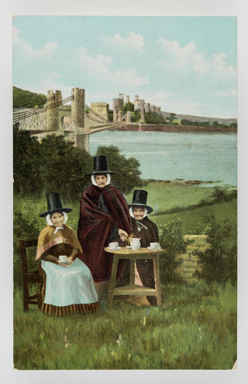 3 Welsh women at tea table - bridge and (?) Conwy Castle in background..