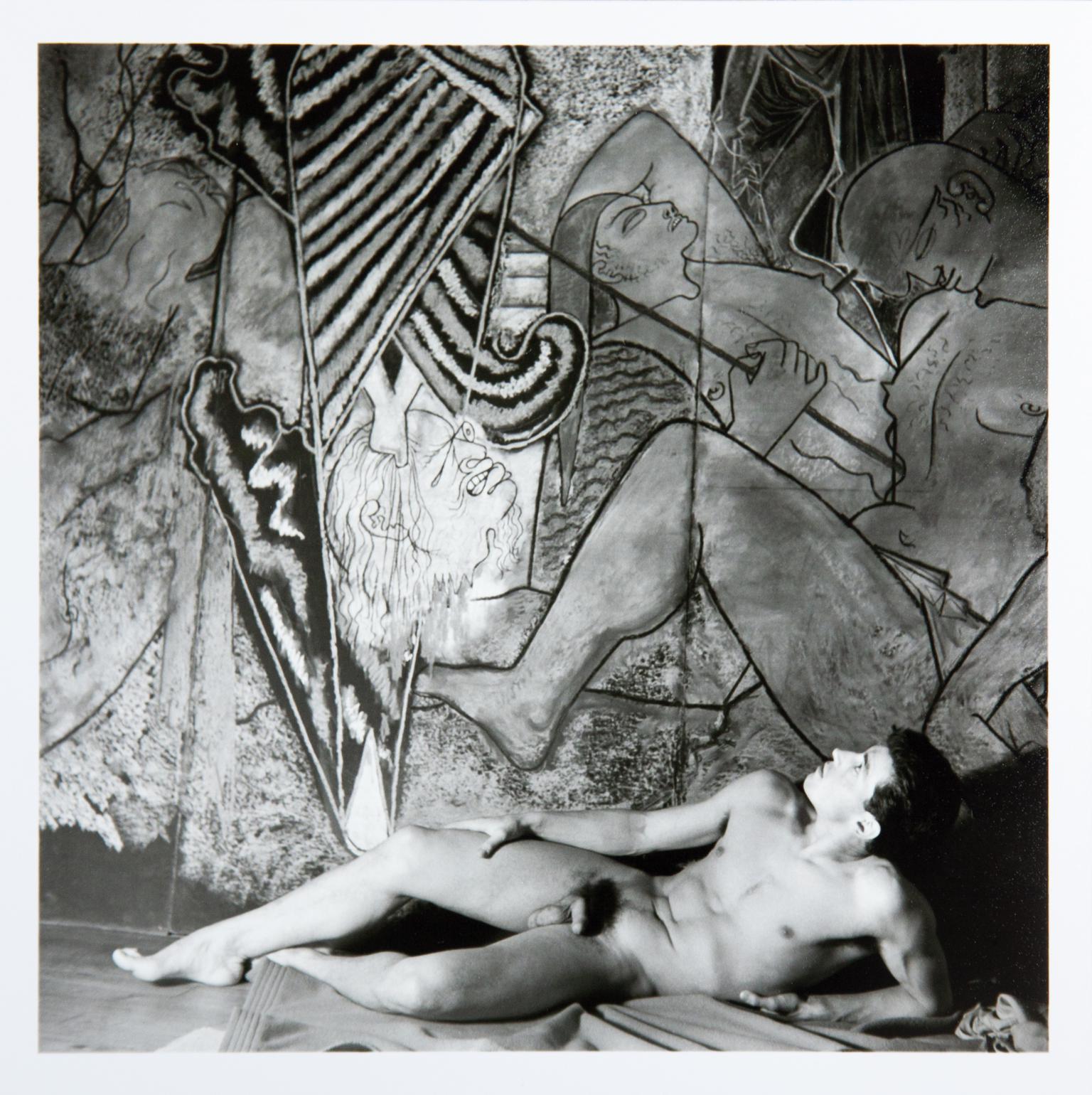 Edouard Dermit in front of Cocteau's pastel drawing "Judith et Holopherne"