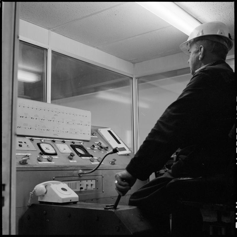 Black and white film negative showing a man operating controls, Betws Mine.  &#039;Betws&#039; is transcribed from original negative bag.