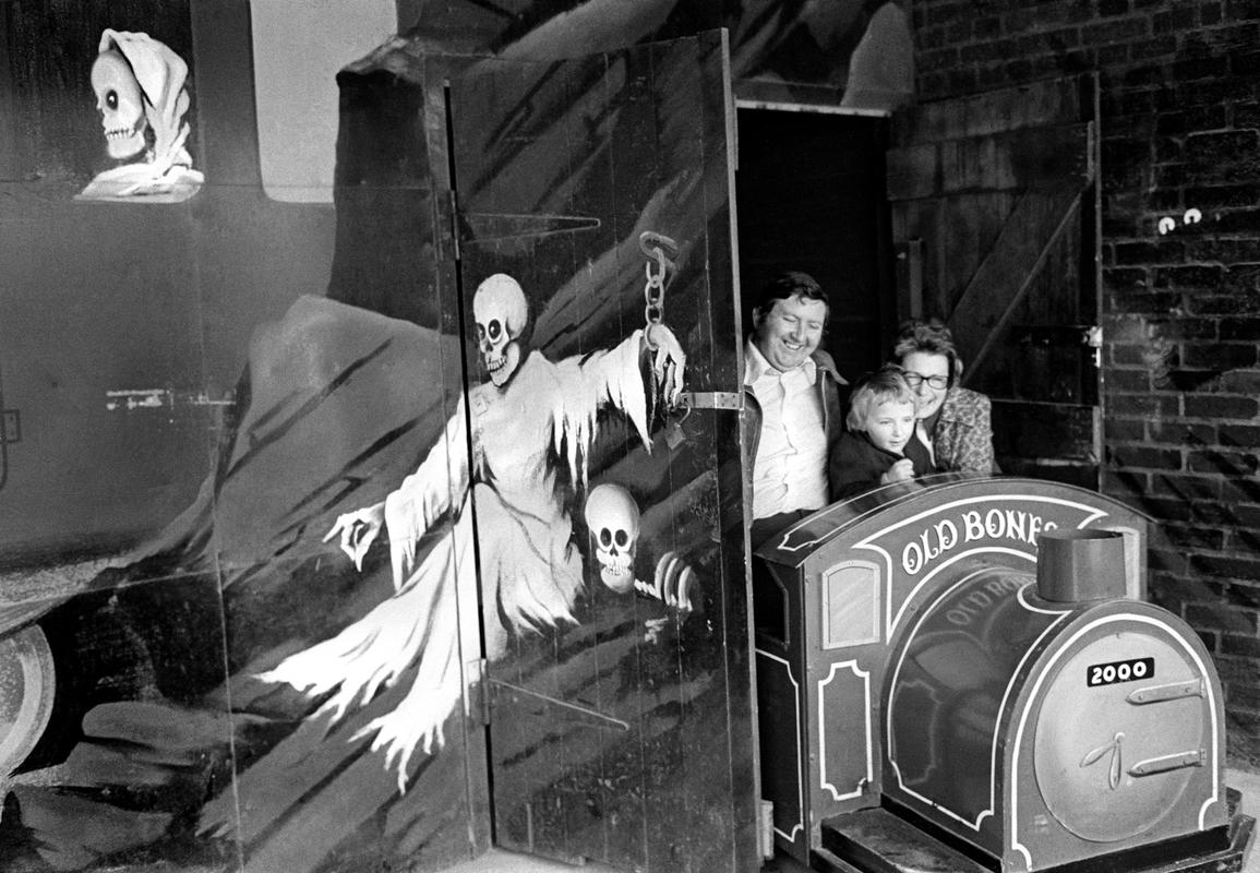GB. WALES. The fun fair at Porthcawl.  A family have the fun/horror of the Ghost Train. 1974