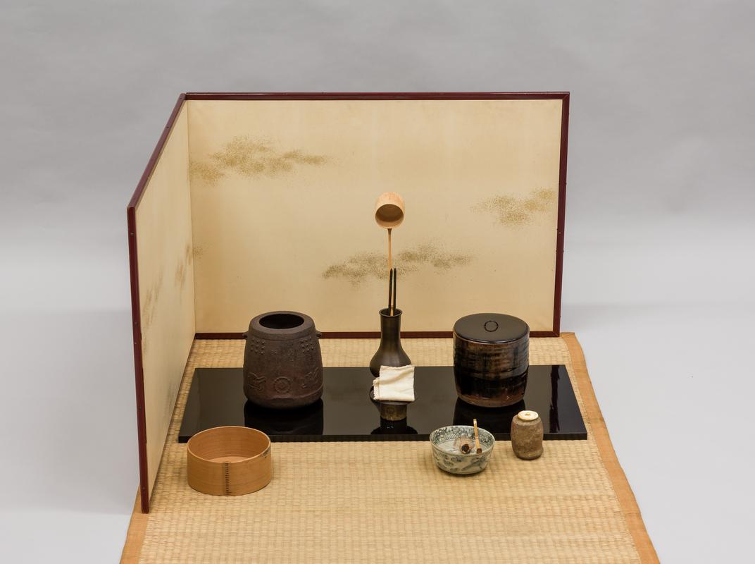 Tea service consisiting of: tatami mat, folding screen (byobu), lacquered board (naga ita), iron kettle (kama), water jar &amp; lid, tea bowl (chawan), tea jar (chaire), lid-rest (futa oki), bamboo tea scoop (chashaku), cedar-wood slop bowl (koboshi), bamboo ladle (shaku), bamboo whisk, bronze ladle stand (shaku tate), pair of iron chopsticks (hibashi), linen cloth.