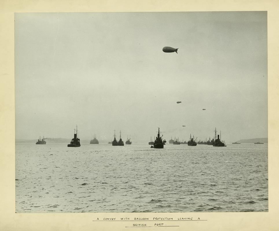 A World War 2 supply-ship convoy, with barrage balloon protection, leaving a British port (probably) Milford Haven