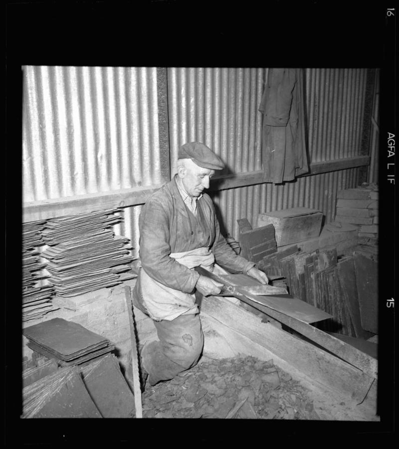 Quarryman dressing a roofing slate using a slate trimming knife, &#039;cyllell naddu/cyllell bach&#039;, Dinorwig Quarry, early 1960s.



According to Emyr Jones, this quarryman was the only one in Dinorwig Quarry still using a trimming knife.