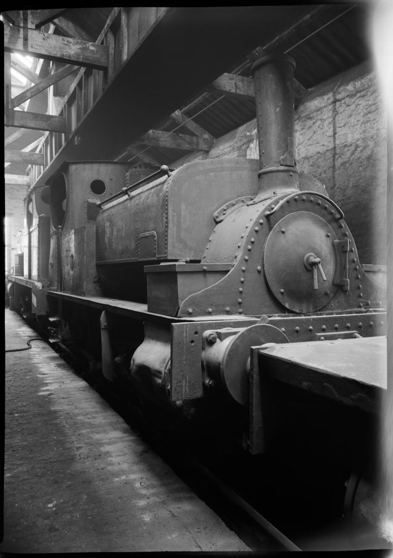 Black and white film negative showing a locomotive inside a locomotive shed, Mountain Ash.