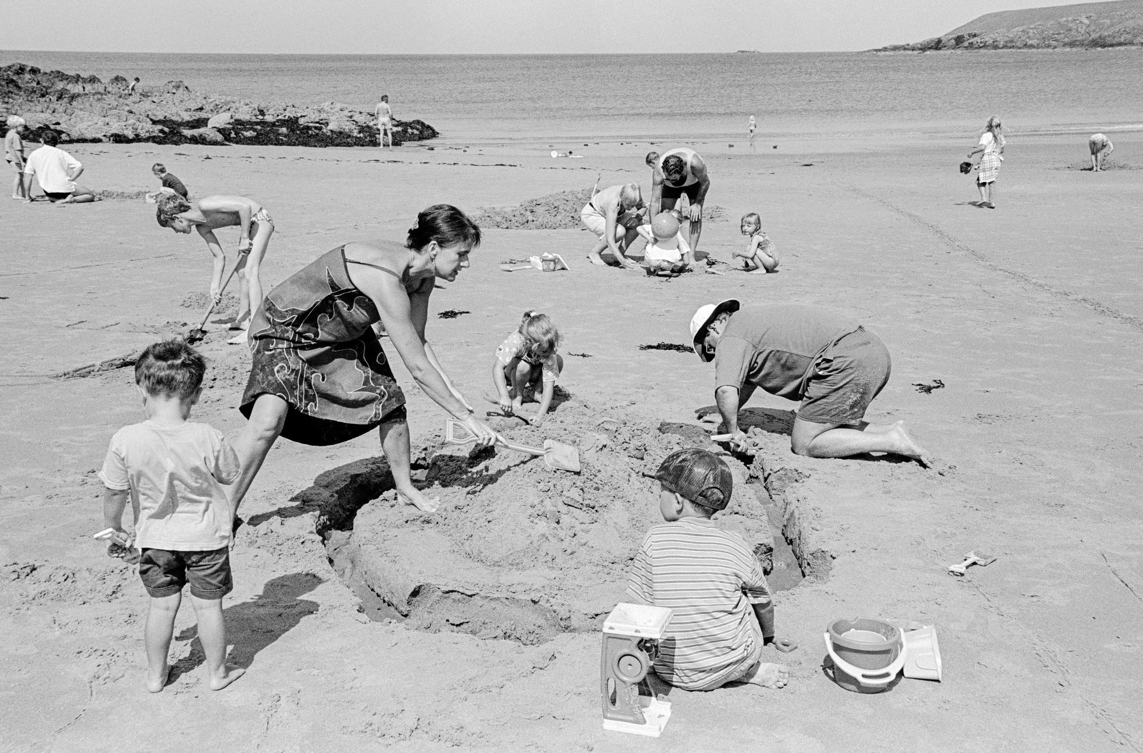 Sandcastle making on the beach. Porthor, Wales