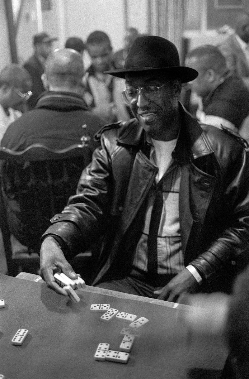 GB. WALES. Cardiff. Butetown - once know as &#039;Tiger Bay&#039;. Laying down the cards at a domino match between Cardiff and London held above Bab&#039;s Bistro (now the Caribean Restraurant), West Bute Street. The player was representing the visiting side. 2000