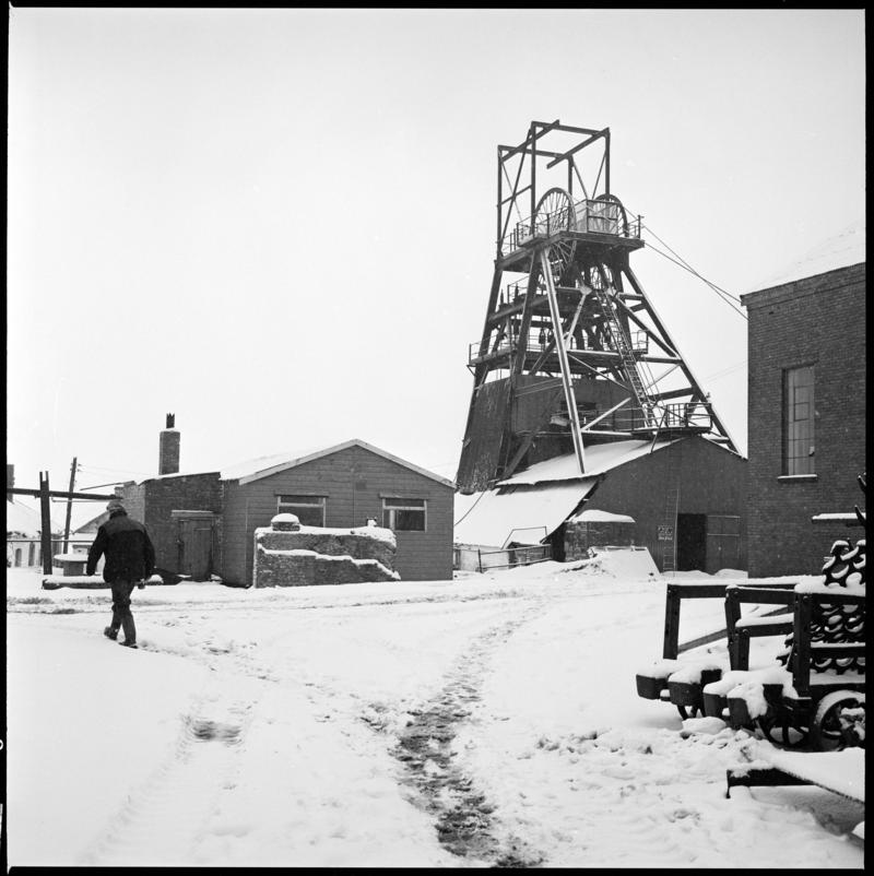 Black and white film negative showing a view towards the headframe, Big Pit.