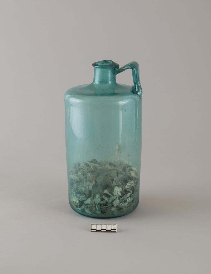 Roman glass bottle with human bones