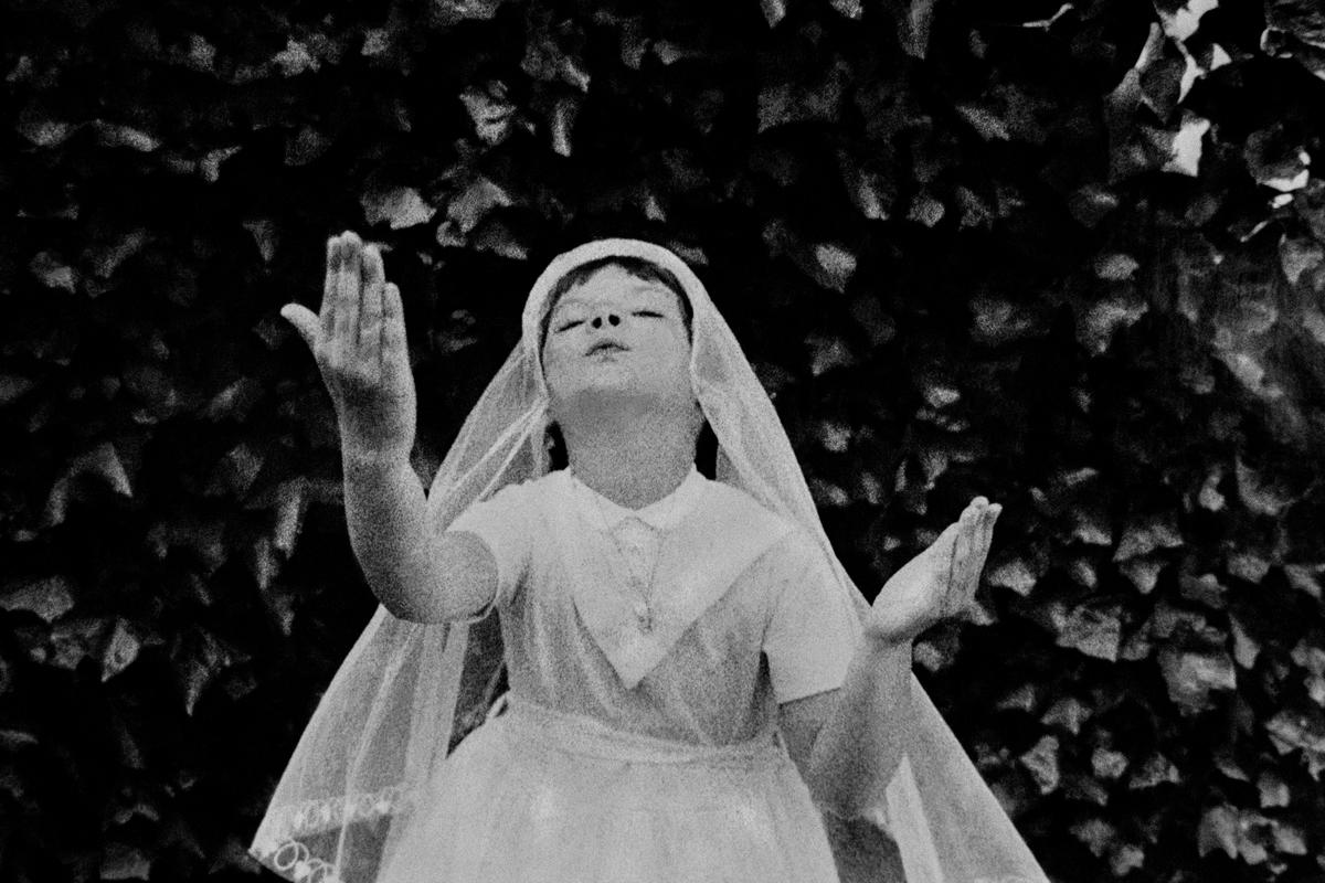 Young girl full of joy after having had her Confirmation service. London, England