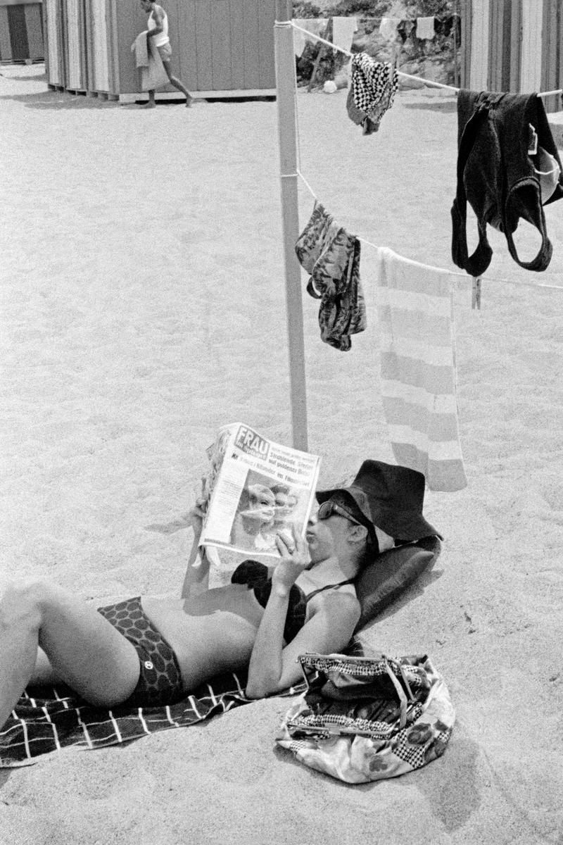 ITALY. Ischia. Reading on the beach. 1964.