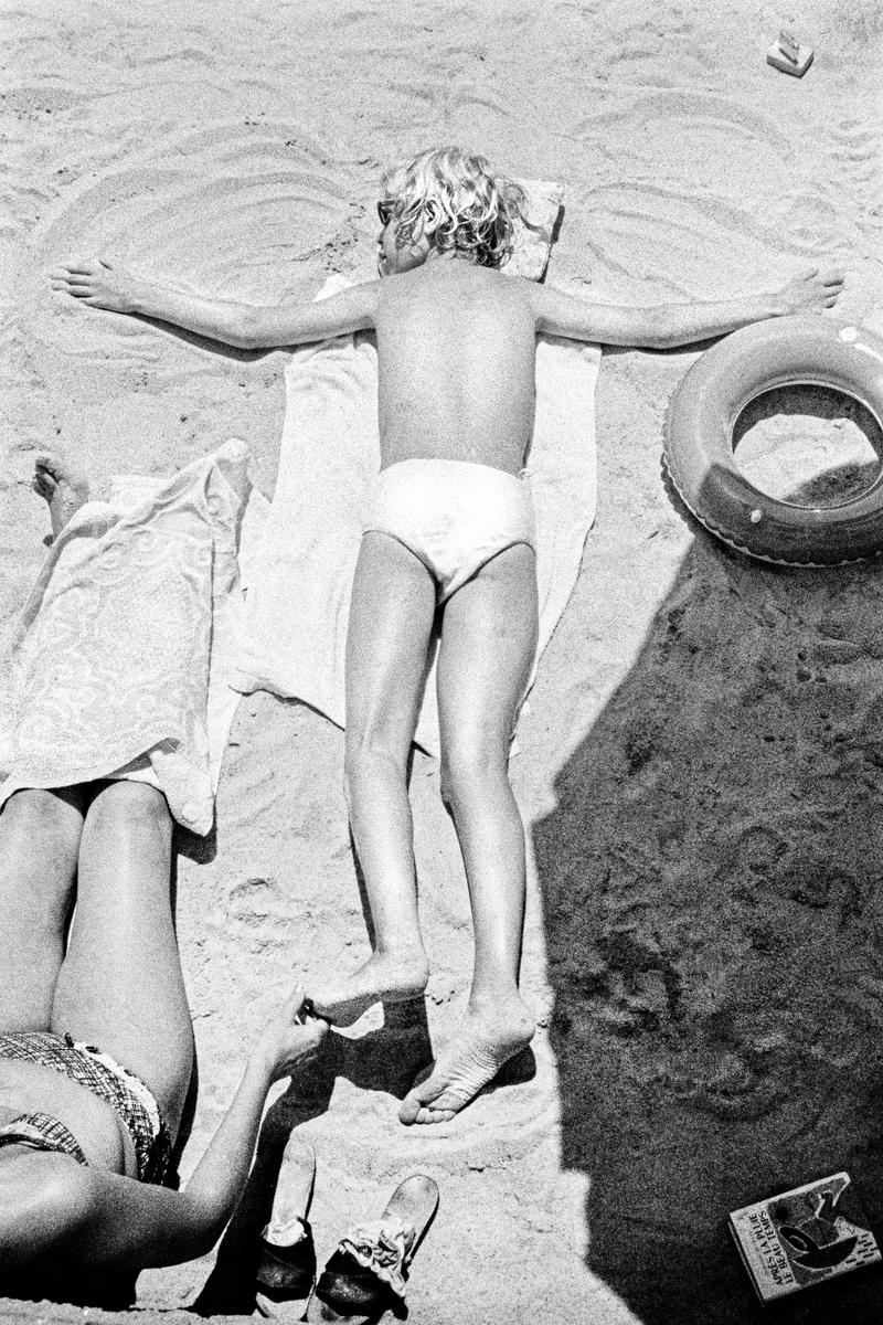 FRANCE. Cannes. Sunning on the sandy beach. 1964.