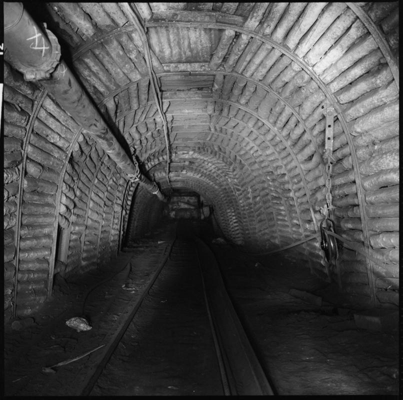 Black and white film negative showing an underground roadway, Tymawr Colliery 21 December 1976.  &#039;Ty Mawr 21/Dec/76&#039; is transcribed from original negative bag.