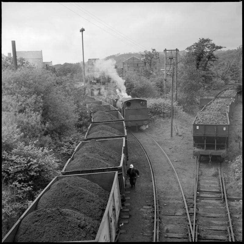 Black and white film negative showing a locomotive and wagons full of coal, 1975.  &#039;Deep Duffryn 1975&#039; is transcribed from original negative bag.