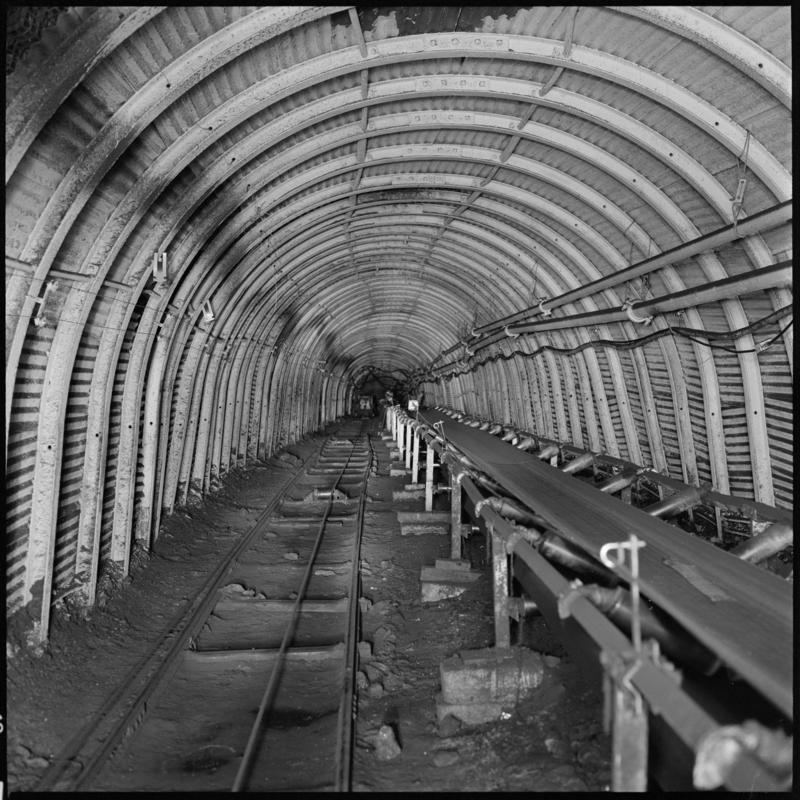 Black and white film negative showing an underground roadway and conveyor, Treforgan Colliery.