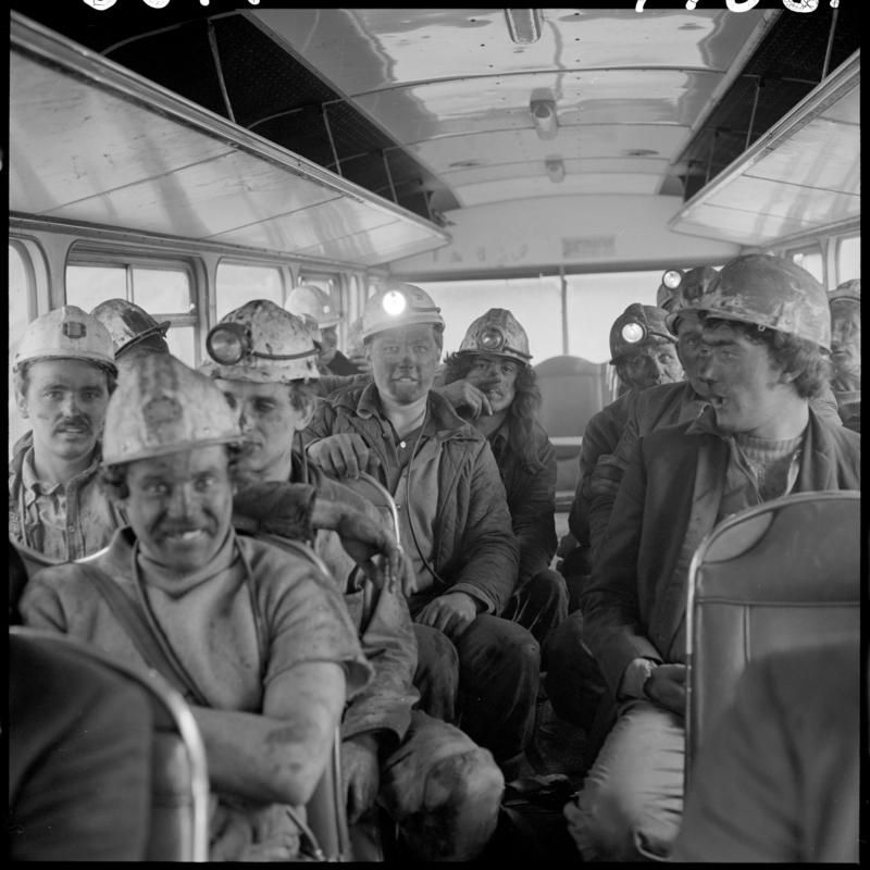 Black and white film negative showing miners sat on the National Coal Board bus in 1978.  It transported them from the Blaenavon Drift Mine to the pit head baths at Big Pit.