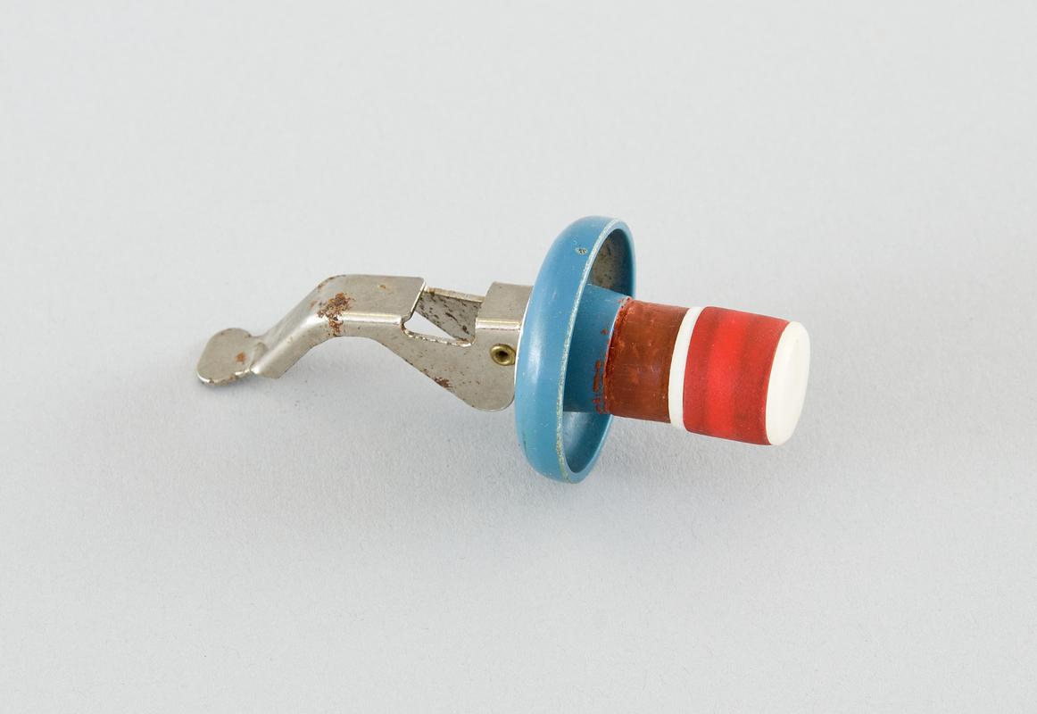 Blue and white plastic bottle stopper with metal release for securing and red rubber to fit in bottle.