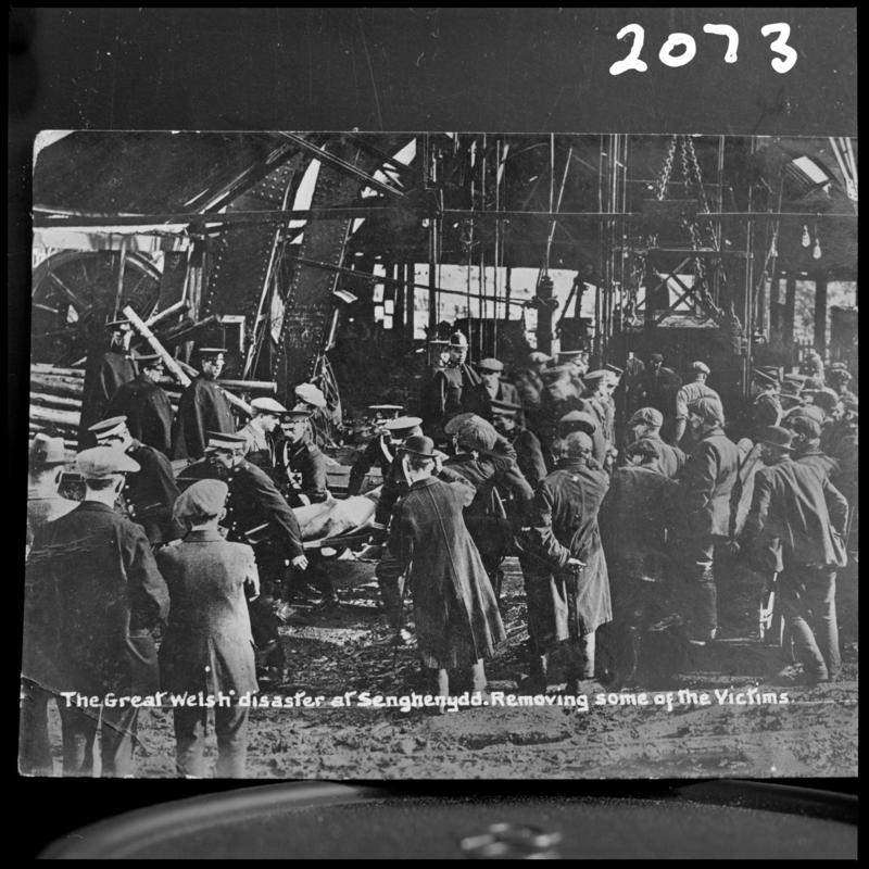Black and white film negative of a photograph showing the scene at Universal Colliery, Senghenydd after the explosion of 14 October 1913.  Caption on photograph reads &#039;the Great Welsh disaster at Senghenydd.  Removing some of the victims&#039;.