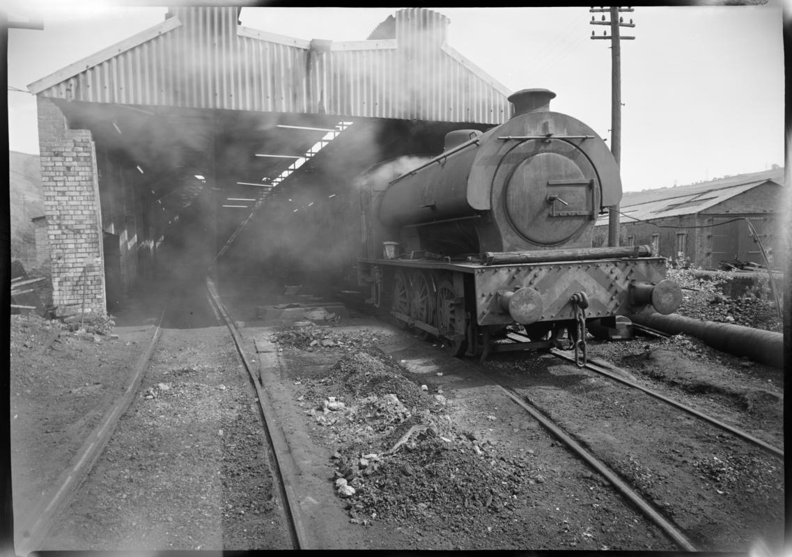 Black and white film negative showing a locomotive at the Mountain Ash locomotive shed, Nixon&#039;s Navigation Colliery.