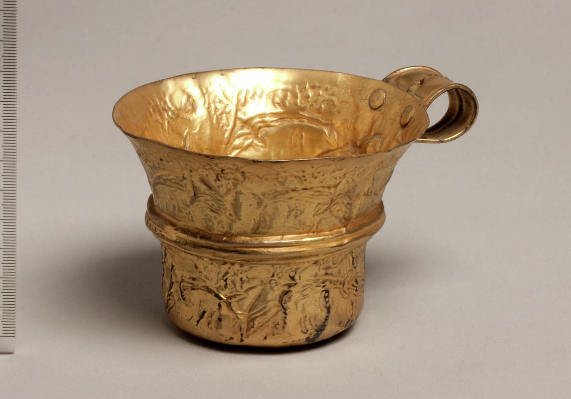 Replica gold cup depicting dolphins