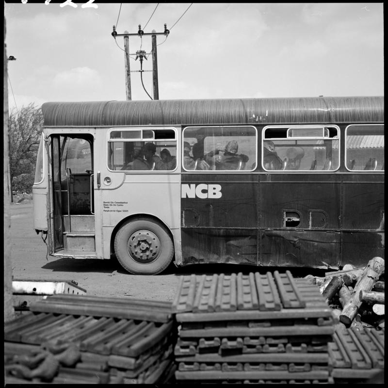 Black and white film negative showing an NCB bus, Big Pit.