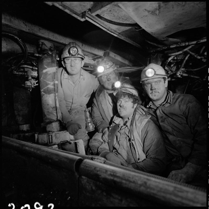 Black and white film negative showing four men underground, Celynen South Colliery.
