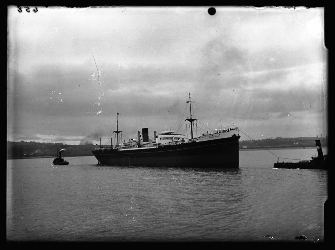 3/4 starboard bow view of M.V. DEVON CITY and tug, c.1936.