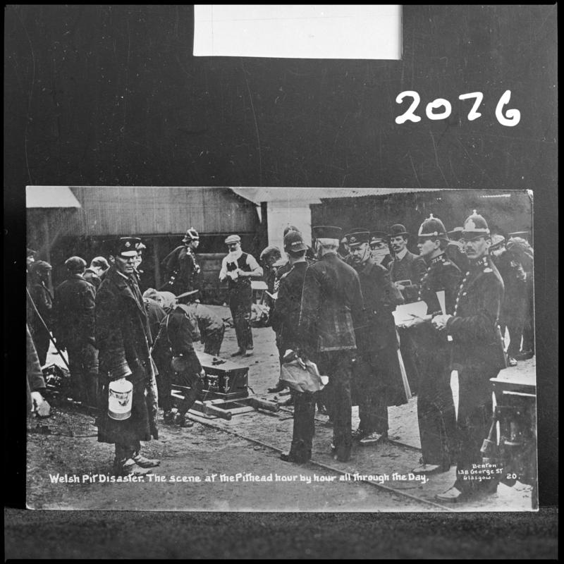 Black and white film negative of a photograph showing the scene at Universal Colliery, Senghenydd after the explosion of 14 October 1913.  Caption on photograph reads &#039;Welsh Pit Disaster.  The scene at the pithead hour by hour all through the day&#039;.