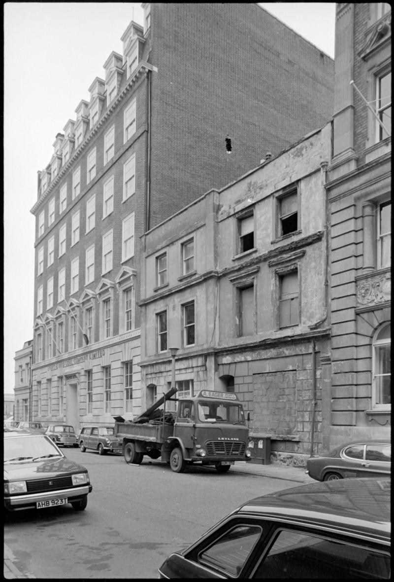 Empire House (Evans and Reid Coal Co. Ltd) next to bricked up buildings in Mountstuart Square, Butetown.