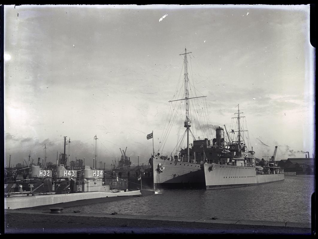 Bow view of a Depot Ship at Cardiff Docks along with Destroyer and submarines H 34, H 43, H 32, c.1937.