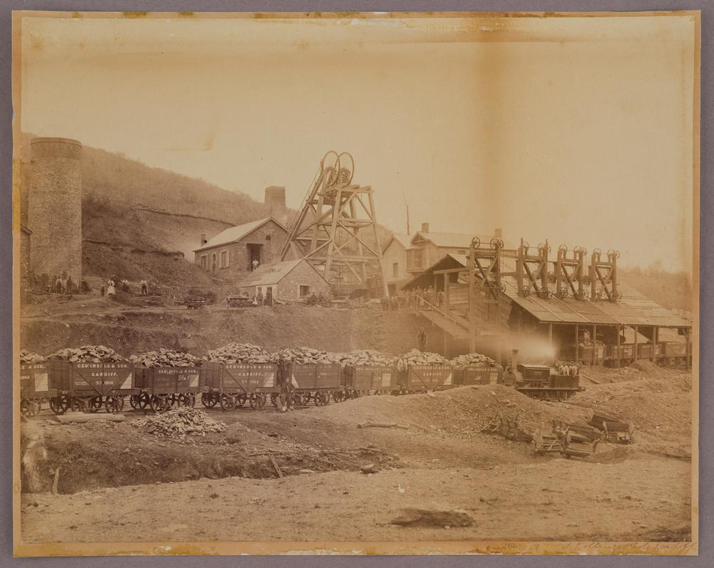 General view of an unidentified colliery in east Glamorgan, c.1880-1890. Shows headgear and lines of George Insole &amp; Son coal wagons.