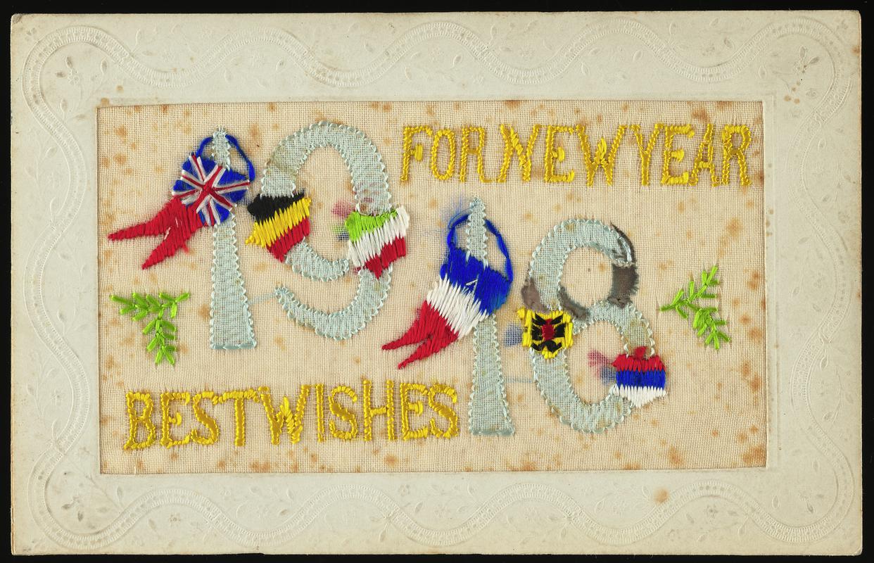 Embroidered postcard inscribed &#039;FOR NEW YEAR 1918 BEST WISHES&#039;. Handwritten message on back. Sent to Miss Evelyn Hussey, sister of Corporal Hector Hussey of the Royal Welch Fusiliers, during the First World War.