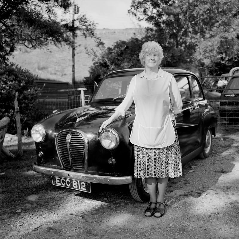 GB. WALES. Cardiff. Margaret Roberts (Peggy) housewife. With her 1957, A35 car. 1996.