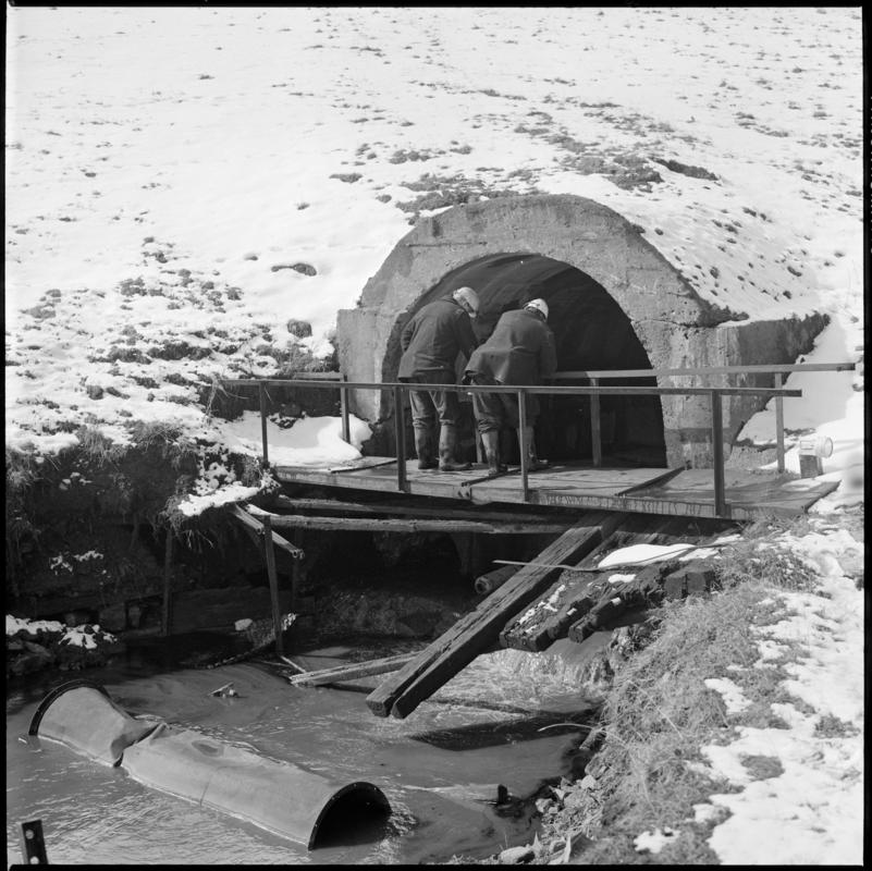 Black and white film negative showing two men at River Arch, Big Pit Colliery.  &#039;River Arch Blaenavon&#039; is transcribed from original negative bag.
