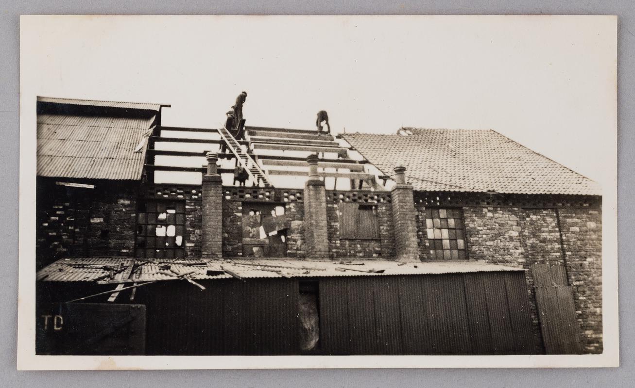 Repairing damaged pantile roof of north end of hot mills building at Bryn Tinplate Works, Ynysmeudwy, June 1935.