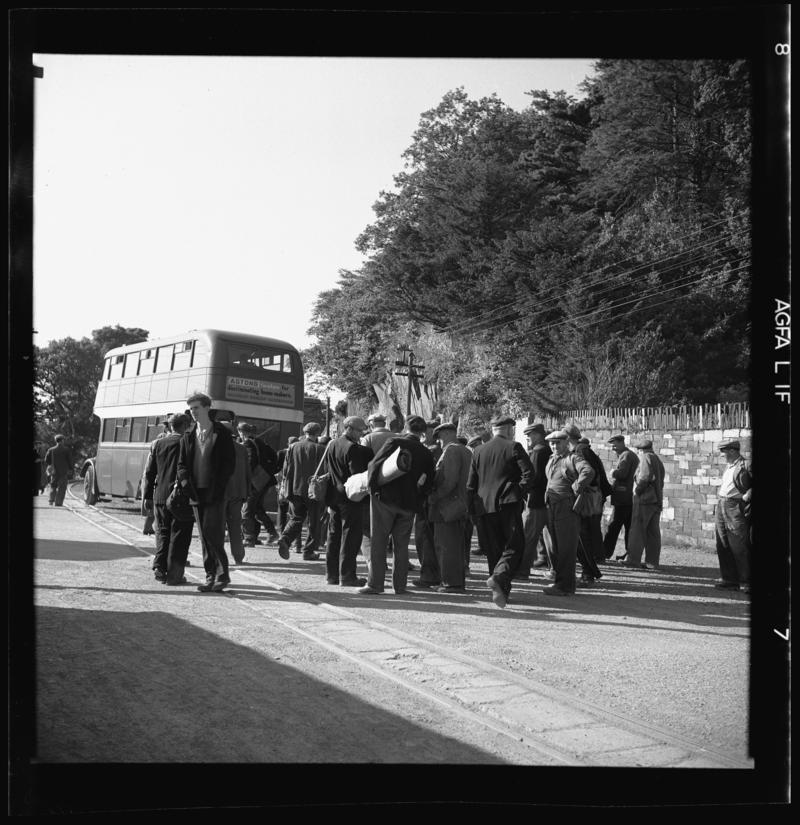 Quarrymen boarding a bus.