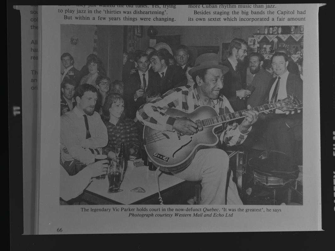 Copy of photograph - &quot;The legendary Vic Parker holds court in the now-defunct Quebec&quot;. The Quebec was situated at the rear of the Custom House pub on Bute Street.