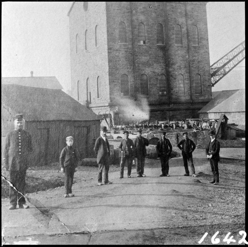 Black and white film negative of a photograph showing a general surface view of Deep Navigation Colliery in 1878.  The engine house housed the vertical winder.  The figure on the left is the colliery policeman.