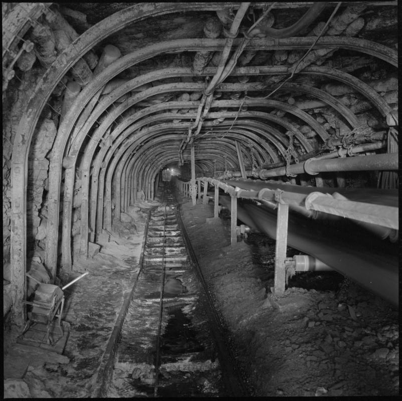 Black and white film negative showing a roadway with conveyor taking coal from the Garw seam to the new drift, Big Pit Colliery 1978.  &#039;Blaenavon 1978&#039; is transcribed from original negative bag.