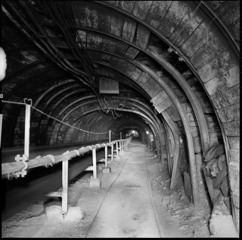 Black and white film negative showing a roadway and conveyor belt, Coegnant Colliery 1978-1979.  &#039;Coegnant 1978-9&#039; is transcribed from original negative bag.