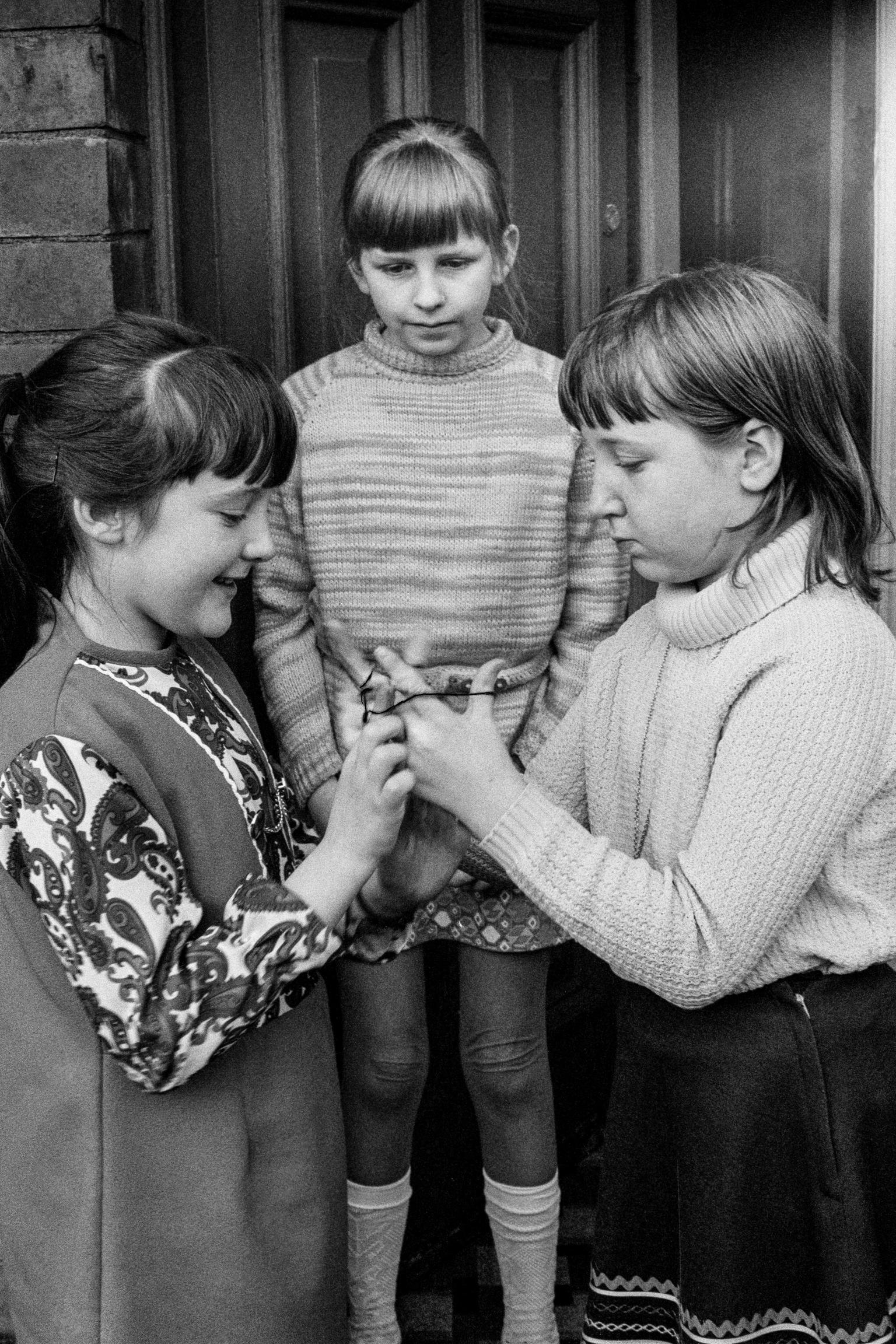 Pill area. Children playing Cats Cradle. Newport, Wales