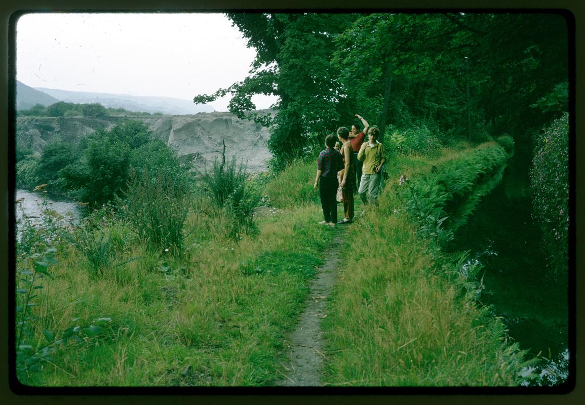 Slide showing a group of children on banks of River Tawe (on right) at southern end of Pontardawe Steel Works slag tips from the south west.