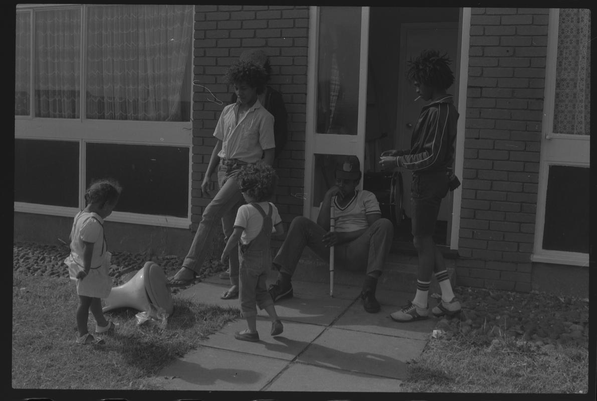 Teenagers and children outside house in Loudoun Square area of Butetown.