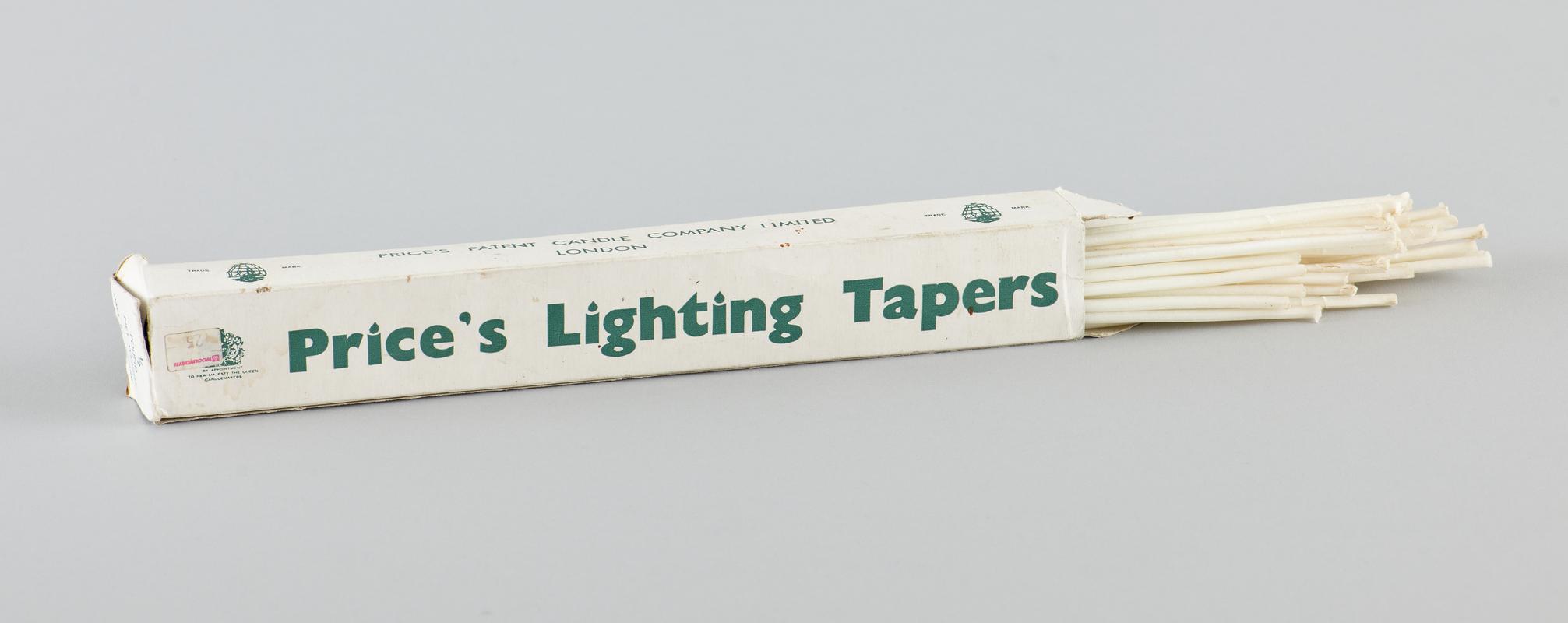 Half pound box of &#039;Prices&#039; wax lighting tapers in original card box. White card with green printed branding, well worn with flap missing from one end. Some of the wax tapers have been removed from box, which is about 75% full.