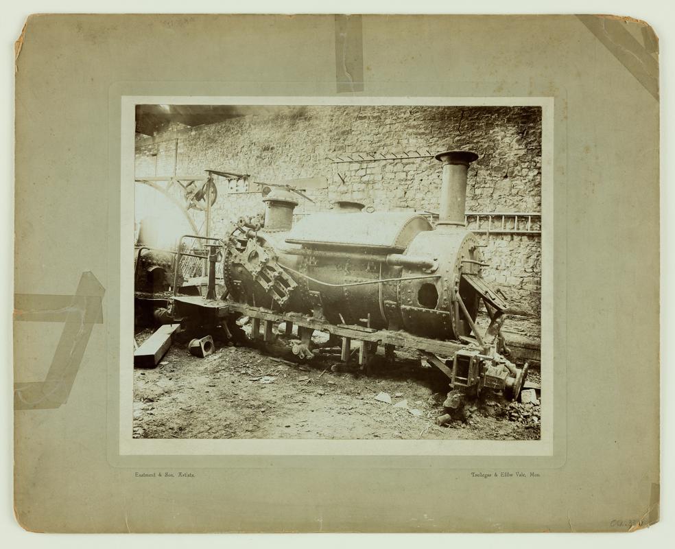 Partly dismantled derelict Tredegar locomotive in workshop.