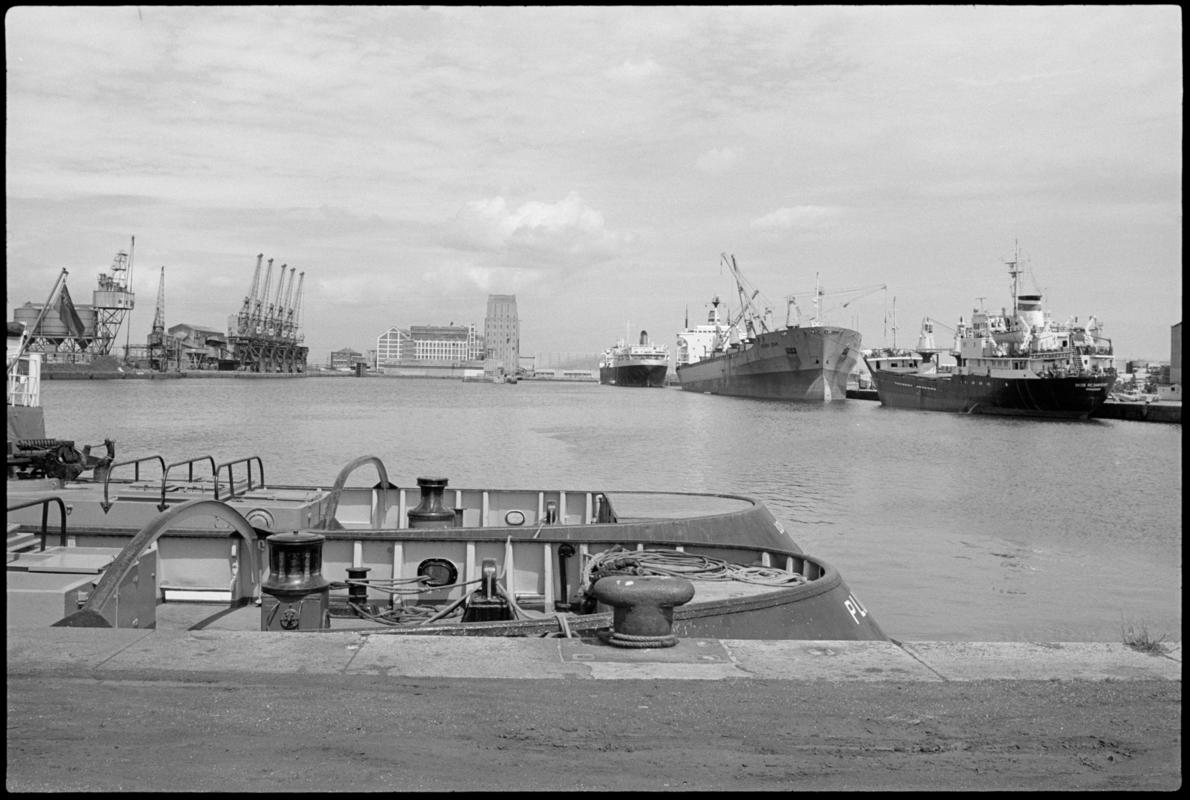 Roath Dock looking North with two spillers in the background, and the sterns of two tugs in the foreground.